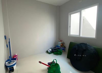 Minimalistic unfurnished room with window and cleaning items