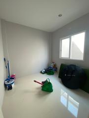 Minimalistic unfurnished room with window and cleaning items