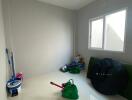 Minimalistic unfurnished room with window and cleaning items