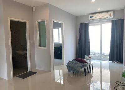 Modern spacious living area with abundant natural light and sleek flooring