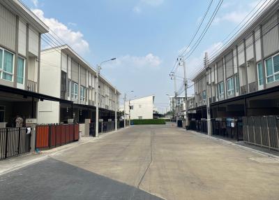 Street view of modern townhouses with clear skies