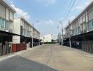 Street view of modern townhouses with clear skies