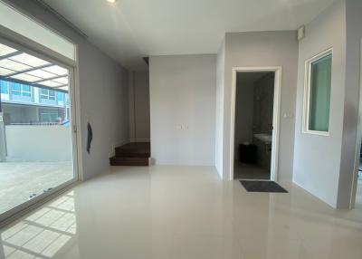 Spacious and bright unfurnished living room with large windows and tiled flooring