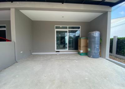 Spacious carport with concrete flooring and covered roof