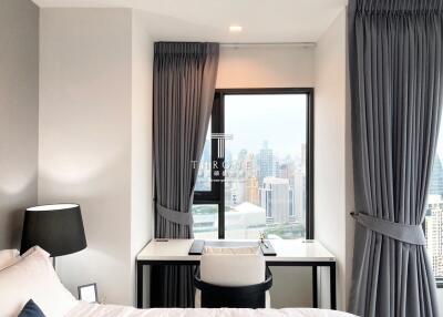 Modern bedroom with city view from large window