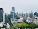 Panoramic view of a modern cityscape with skyscrapers and green spaces