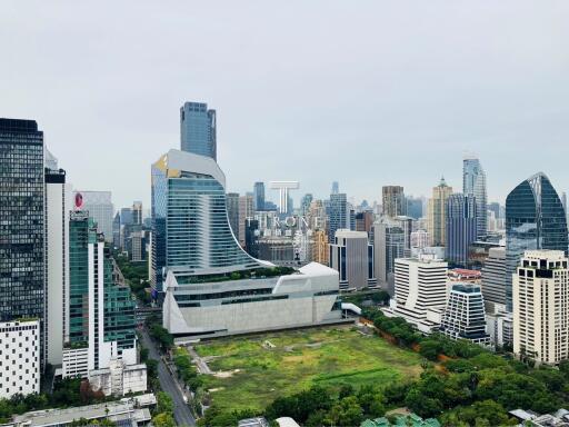 Panoramic view of a modern cityscape with skyscrapers and green spaces