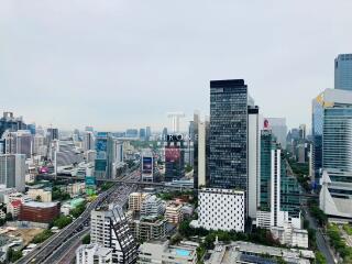 Aerial view of a bustling cityscape with modern skyscrapers and urban infrastructure