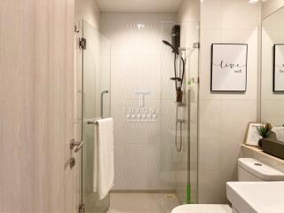 Spacious modern bathroom with glass shower enclosure