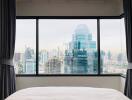 Bedroom with large window overlooking cityscape