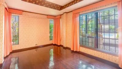 Spacious living room with large windows and polished hardwood floors