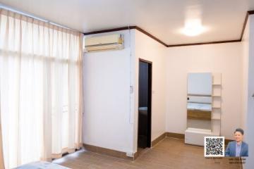 Cozy bedroom with air conditioning and tiled flooring