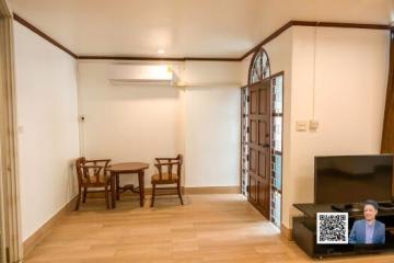 Spacious living room with wooden flooring and glass doors