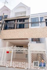 Facade of a multi-story residential building with gated entrance