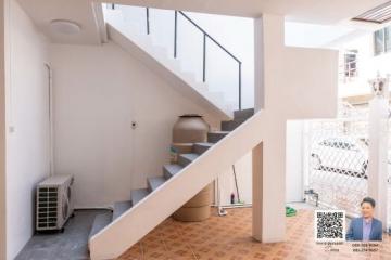 Bright and airy stairway area leading to the upper floor of the house with tiled flooring