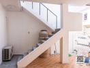 Bright and airy stairway area leading to the upper floor of the house with tiled flooring