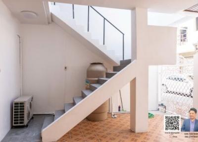 Bright and airy stairway area leading to the upper floor of the house with tiled flooring