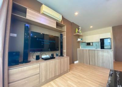 Modern living room with entertainment unit and open kitchen design