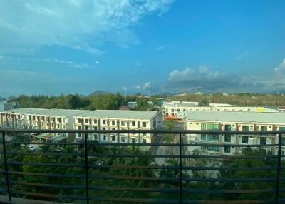 View from the balcony overlooking a residential area with clear skies