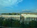 View from the balcony overlooking a residential area with clear skies