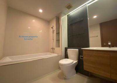 Modern bathroom with bathtub and wooden vanity
