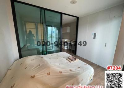 Modern bedroom with large window and access to balcony