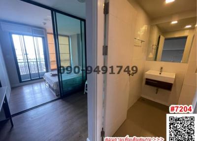 Modern bedroom connected to a bathroom with sliding glass doors and city view