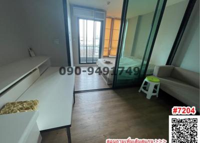 Spacious bedroom with large window and direct access to balcony