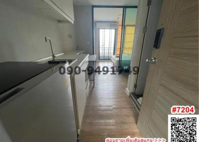 Modern kitchen with wooden floor leading to a balcony