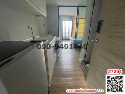 Modern kitchen with wooden floor leading to a balcony