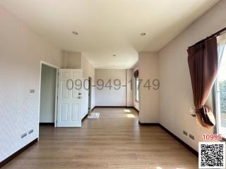 Spacious bedroom with hardwood floors and ample natural light