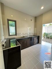 Modern kitchen with dark cabinets and stainless steel fixtures