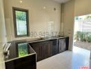 Modern kitchen with dark cabinets and stainless steel fixtures