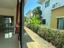 Patio area with large glass windows and view of exterior garden