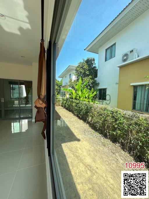 Patio area with large glass windows and view of exterior garden