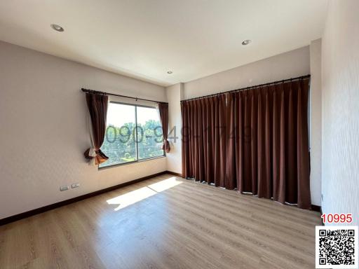 Spacious bedroom with large windows and natural light