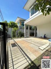 Spacious house exterior with driveway and shaded carport