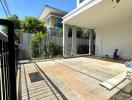 Spacious house exterior with driveway and shaded carport