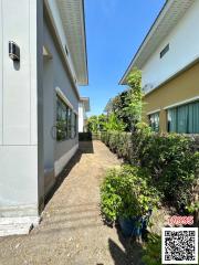 Exterior view of a residential building with garden pathway