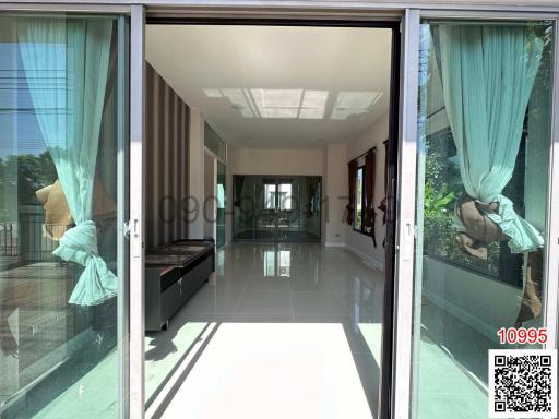 Spacious patio entrance with sliding doors leading into a well-lit living room