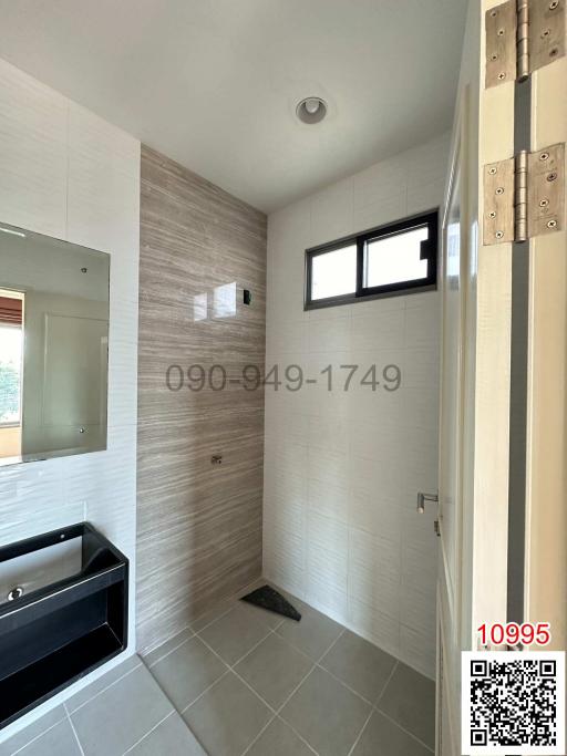 Modern bathroom with walk-in shower and stylish tiling