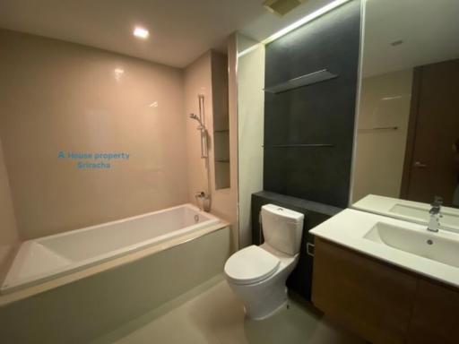 Modern bathroom with bathtub, toilet and vanity