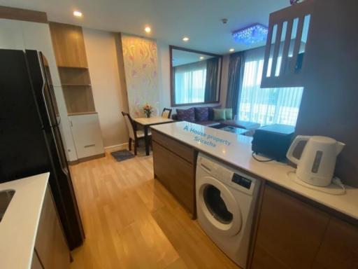 Modern kitchen with integrated appliances and open plan dining area