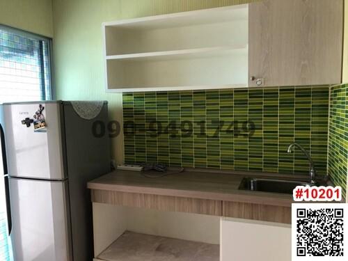 Modern kitchen with green tile backsplash and wooden countertop