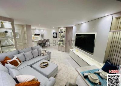 Elegant and spacious living room with modern furnishings and large flat screen TV