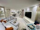 Elegant and spacious living room with modern furnishings and large flat screen TV