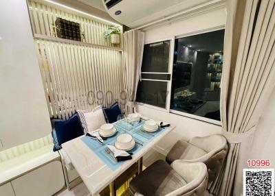 Cozy dining area with a modern table set for four and ample natural light from window