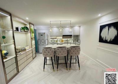 Modern kitchen with bar stools and elegant lighting