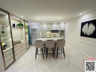 Modern kitchen with bar stools and elegant lighting