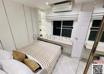 Modern bedroom with a large bed, air conditioning, and mirrored wardrobe